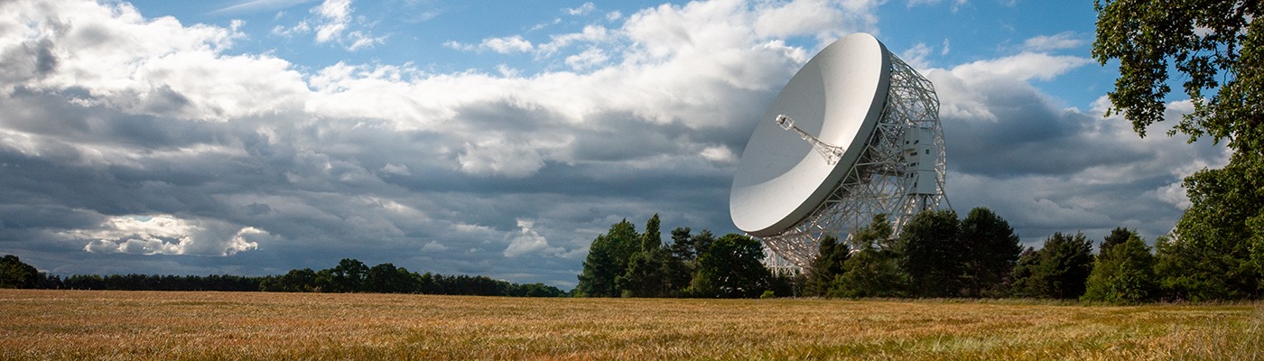 The Lovell Telescope with a field in the foreground 