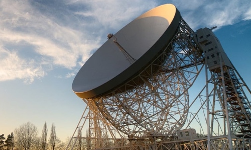 Jodrell telescope pointed up to a cloudy sky