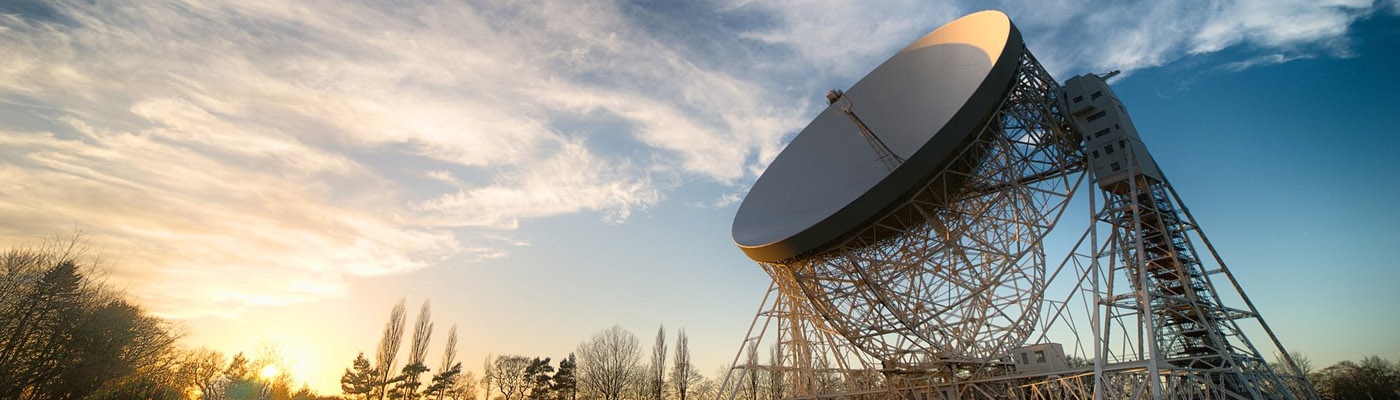 Jodrell telescope pointing up at a cloudy sky 