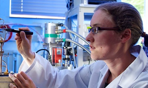 Female student working on equipment in lab