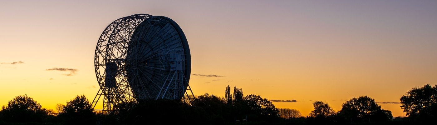 Jodrell bank telescope against a backdrop of sunset